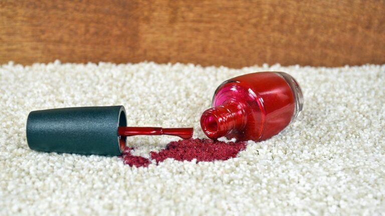 Nail polish spill on carpet being removed with cleaning supplies and step-by-step method