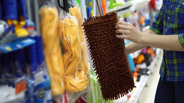 Commercial cleaner using a microfiber mop for fast, hygienic floor cleaning in a modern facility